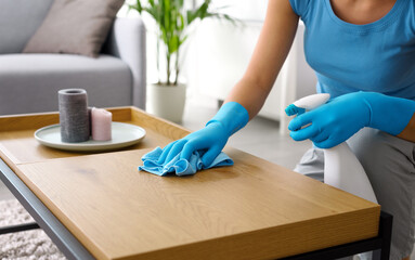 Fototapeta Woman cleaning a table at home obraz