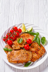 tomato basil pesto fried pork cutlets on plate