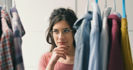 Woman choosing clothes on a rack