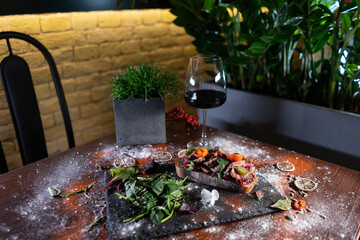 fresh crusty sandwich with roast beef, vegetables, tomato, cucumber and wine