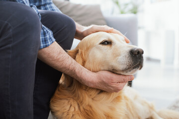 Man cuddling his beautiful dog