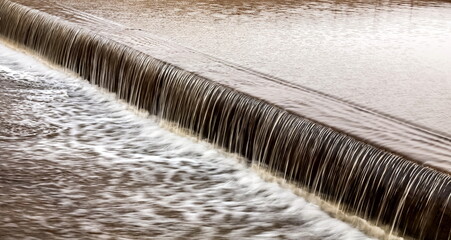 A small waterfall on the river in close-up in spring. Russia. Ural.