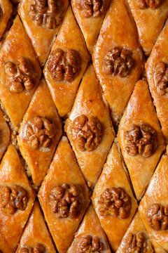 Pattern Turkish baklava with walnuts in honey glaze. Oriental sweet pastry top view