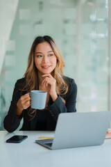 Asian business woman Working on laptop on desk . Independent woman reading financial graph chart. Marketing analysis planning hand of a girl working in the office