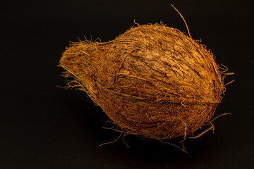 Dried coconut with extreme details of its body texture and hair, isolated in black background and in white background, studio lighting, standing tall and lying down, different angles and composition. 