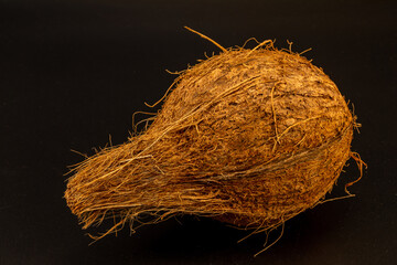 Dried coconut with extreme details of its body texture and hair, isolated in black background and in white background, studio lighting, standing tall and lying down, different angles and composition. 