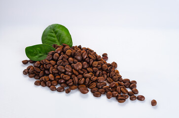 group of coffee beans with green leaves. coffee grains and leaves on a white background
