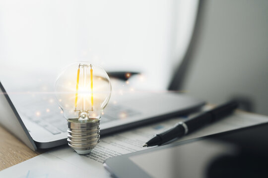 Laptop and glowing light bulb. Business working or learning success idea. Student education knowledge achievement. Studying, skill training online or e-learning at home.