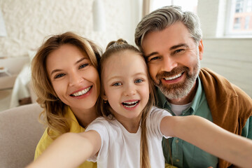 Happy Parents And Daughter Making Selfie Smiling Posing At Home