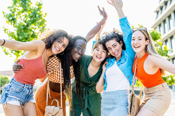 Group of five young women smiling and having fun, female university students celebrating their...