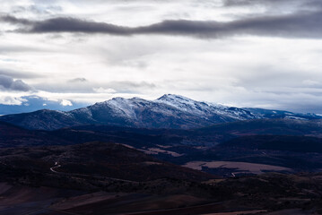 Fototapeta na wymiar View of the peak Ocejon belonging to the mountain range of Ayllon in Guadalajara. Snowcapped peaks during wintertime