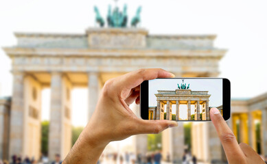 tourist taking a picture with your mobile phone brandenburg gate