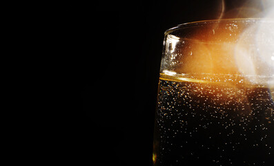 Glass of champagne with ice cubes close-up.