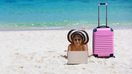 Happy moment with young woman freelancer lying as working on the beach-Summer vacation concept