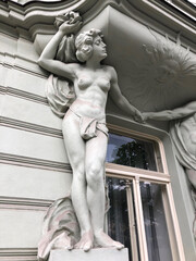 Fototapeta na wymiar Topless female figure supporting a balcony