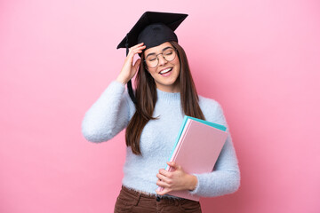 Young student Brazilian woman wearing graduated hat isolated on pink background smiling a lot