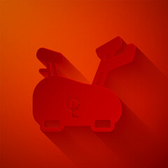 Paper cut Stationary bicycle icon isolated on red background. Exercise bike. Paper art style. Vector