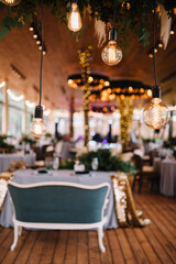 Vintage style light bulbs hanging from the ceiling. Wedding and holidays concept