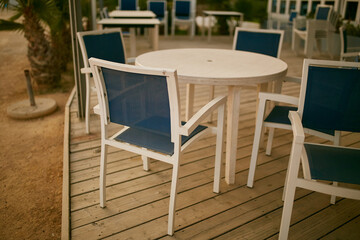 White-blue chairs on the coast in a restaurant. 