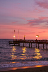 Pier at sunset. Sunset on the Mediterranean Sea.