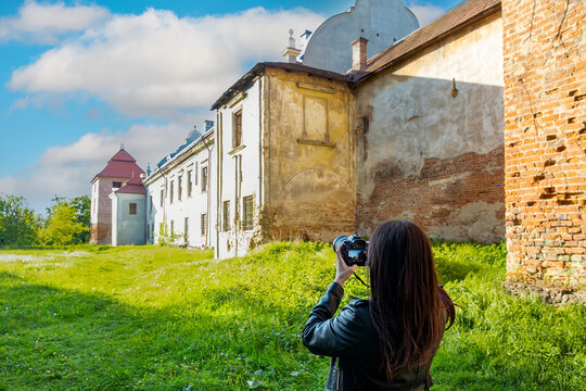Tourist photographs Zhovkva Castle in Zhovkva. Ukraine. Selective focus.