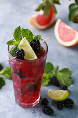 Summer. Drinks and cocktails. Mojito diablo. Beverage with grapefruit, blackberries and currants with ice and fresh mint in a glass on a light background. Summer. Background image, copy space