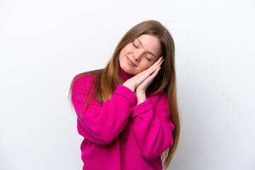 Young caucasian woman isolated on white background making sleep gesture in dorable expression
