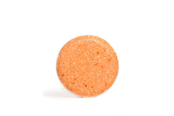 
gum candy or orange vitamin c tablet on white background with space for text
