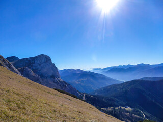 Panoramic view on a massive mountain chains in Kaiserau Kreuzkogel region, Austrian Alps. The steep slopes are overgrown with grass. Sharp peaks. Dangerous mountaineering. Sunny summer day. Adventure