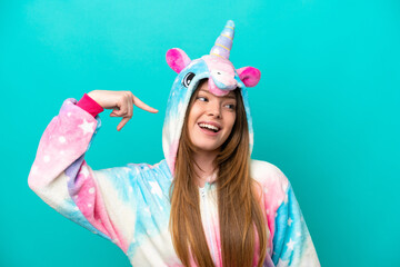 Young caucasian girl with unicorn pajamas holding pillow  smiling with a sweet expression