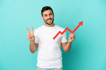 Young handsome caucasian man isolated on blue background holding a catching a rising arrow and...