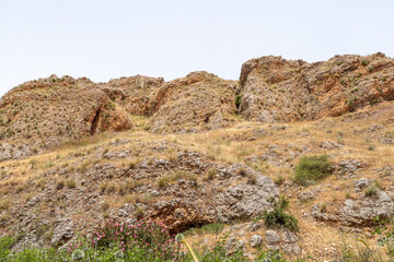 Overgrown  with grass and bushes, the slope of Mount Arbel, located on the shores of Lake Kinneret - the Sea of Galilee, near the city of Tiberias, in northern Israel.