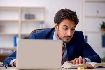 Young male employee working in the office