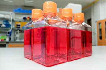 Bottles with cell culture medium containing nutrients essential for cell survival