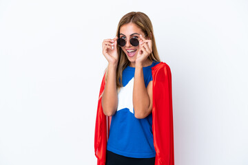 Super Hero caucasian woman isolated background with glasses and surprised