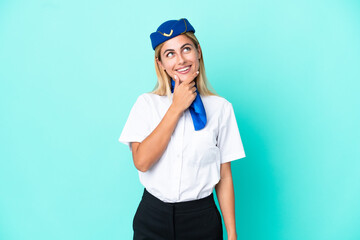 Airplane stewardess Uruguayan woman isolated on blue background looking to the side