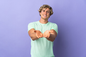 English man over isolated purple background holding copyspace imaginary on the palm to insert an ad