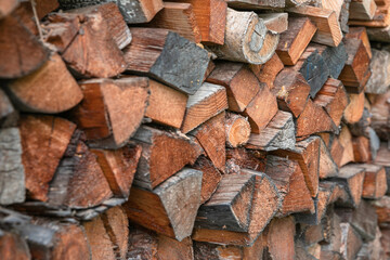 Winter preparation. Stacking Firewood. Pile of firewood loggs. Firewood background. Dry chopped firewood logs in a pile.