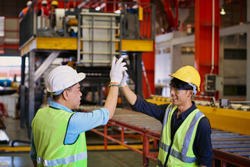 Two factory Workers join stacking hand together for collaboration in Metal Sheet manufacturer