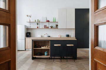 Kitchen interior with wooden cabinet, dining table and countertop
