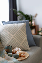 Delicious croissant and chinese tea on couch