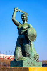 Warsaw Mermaid statue Syrenka at Wybrzeze Kosciuszkowskie over Vistula river in Powisle downtown...