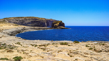 Dewijra bay and Fungus Rock on the Mediterranean island of Gozo in the Maltese archipelago. 