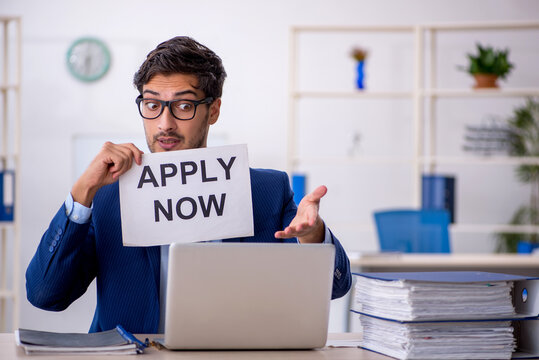 Young businessman employee and too much work in the office