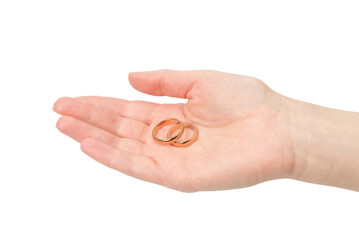 Two golden rings in a woman hand isolated on a white background.