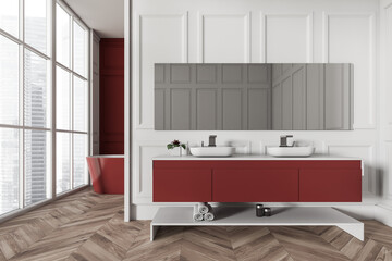 Light bathroom interior with sink and tub near panoramic window