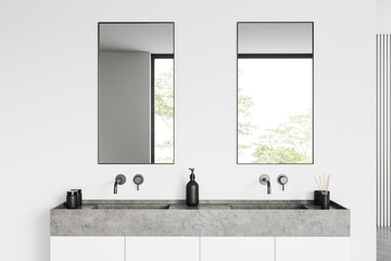 Light bathroom interior with sink and two mirrors, window