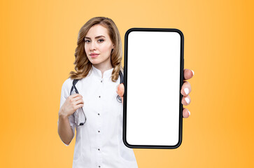Woman doctor showing phone, mockup display on bright background