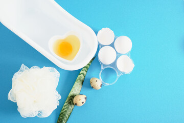 chicken egg shells, quail eggs, a heart-shaped bowl with a raw egg for making a face and hair mask, natural cosmetics