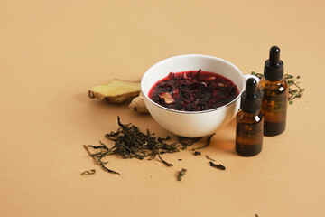 hibiscus brewed tea in a cup and two dropper bottles with pipettes, drink additives, anti-stress...